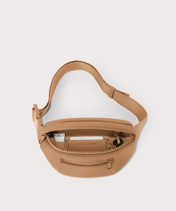 Dagne Dover Ace Fanny Pack in  camel  unzipped, exposing the interior pockets