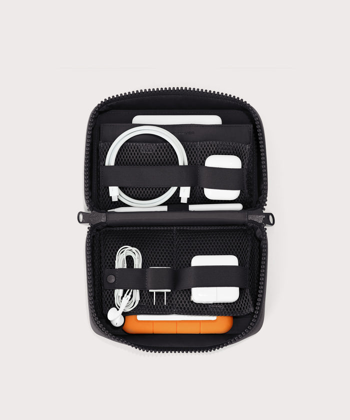 hover - Dagne Dover large Arlo Tech Organizer in black unzipped, revealing the interior elastic loops and airmesh pockets.