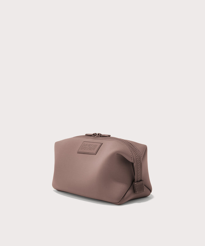 Dagne Dover Large Hunter Toiletry Bag in pink seen from an angle.