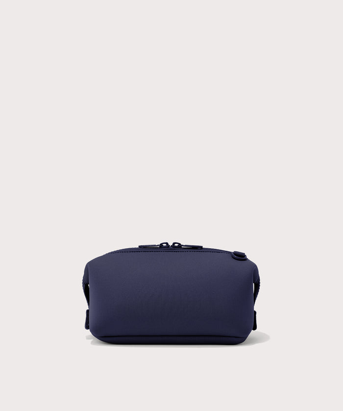 Dagne Dover Small Hunter Toiletry Bag in dark blue seen from the back.