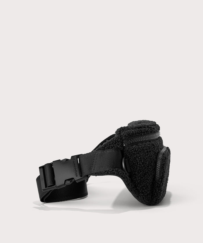 Jax fanny pack in a black. Side angle view  In a  Faux Shearling  a soft, wool-like plush made with recycled materials