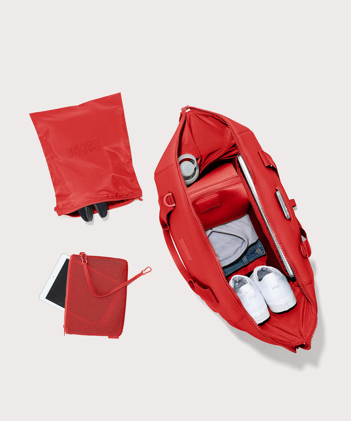 Dagne Dover Extra Large Landon Carryall in a fiery, saturated red leaning toward orange unzipped, top down view.