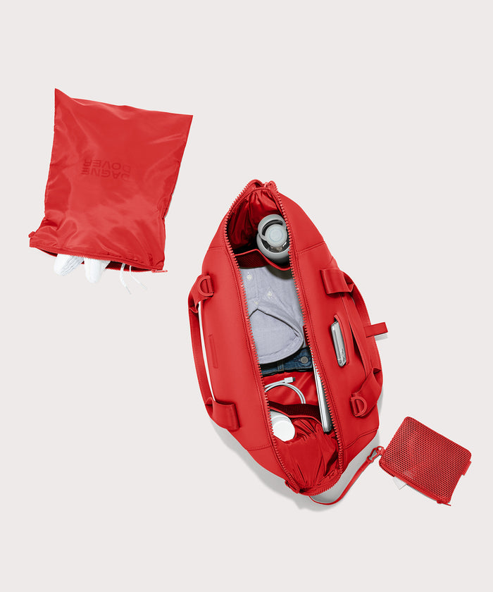 Dagne Dover Large Landon Carryall in a fiery, saturated red leaning toward orange unzipped, top down view.