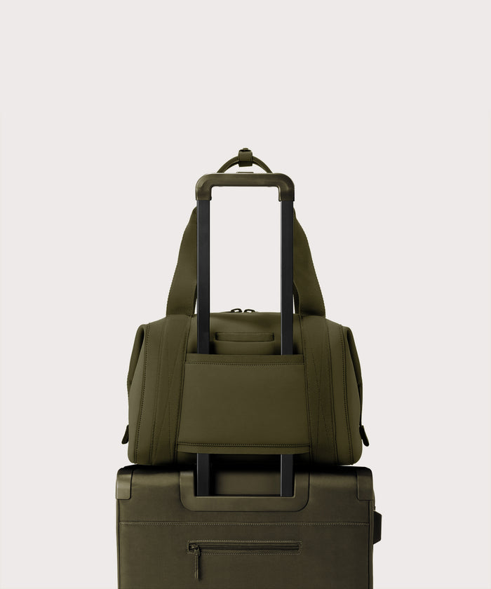 Large Landon Carryall in dark green displaying luggage sleeve