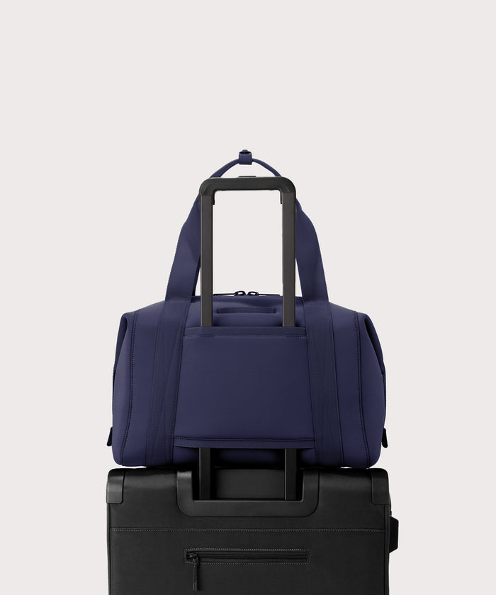 Large Landon Carryall in navy blue displaying luggage sleeve