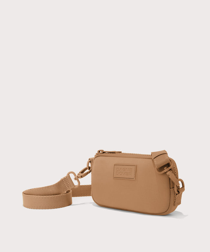 Dagne Dover Mara Phone Sling in brown camel seen from an angle, showing the adjustable shoulder strap drop.