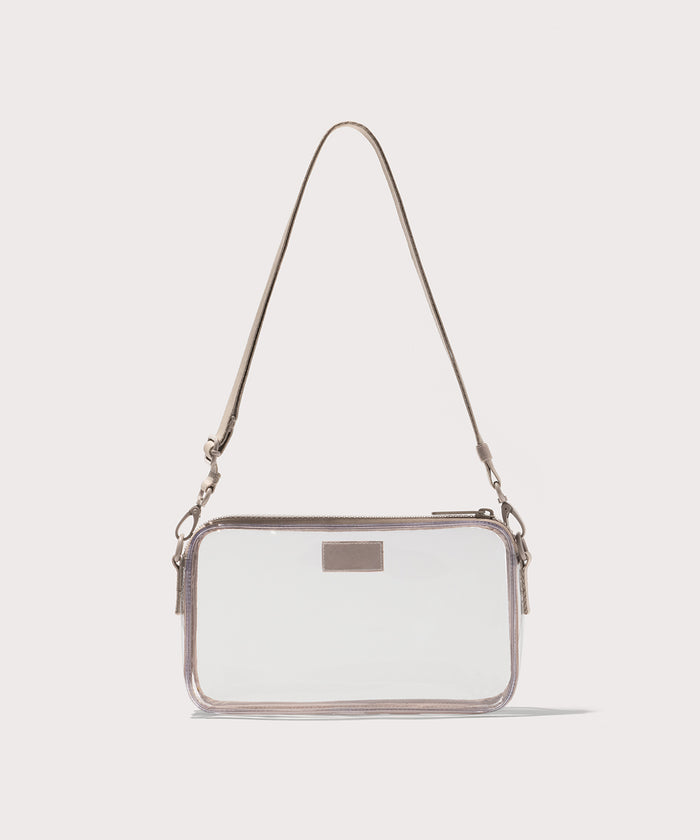 Clear crossbody bag with a beige strap on a white background. Stadium compliant.