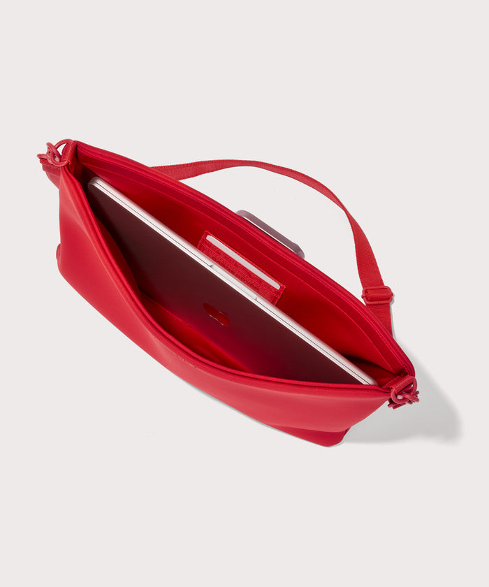 16 inch laptop shoulder  bag in a fiery, saturated red leaning toward orange seen from the top down view showing interior.