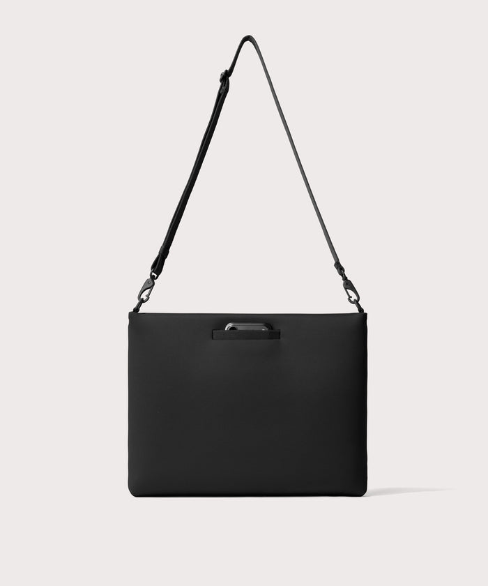 16 inch laptop shoulder bag in a  black seen from the back view showing phone pocket.’