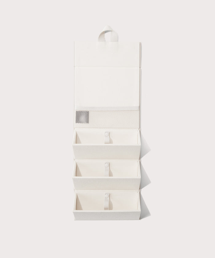 Dagne Dover Remi foldable glasses holder in white hung up.