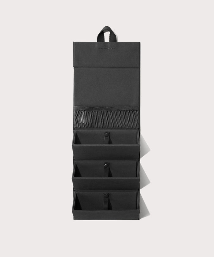 Dagne Dover Remi foldable glasses holder in black hung up.