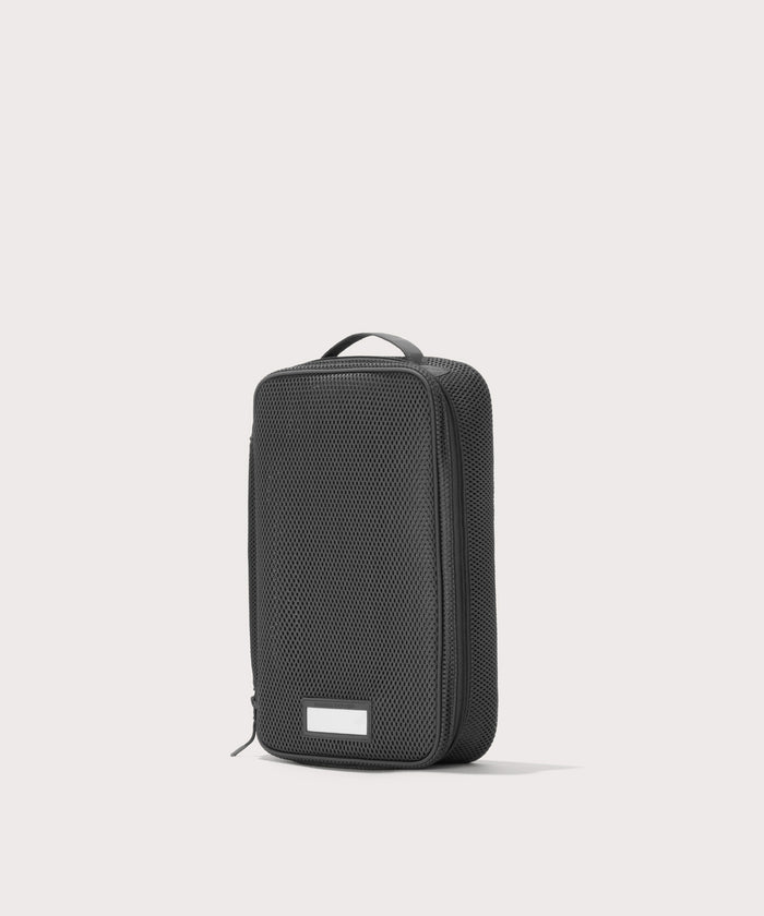 3/4 view of medium Roma packing cube in carbon black