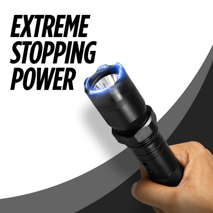 Hand holding a black tactical flashlight stun gun